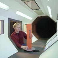 A set of photographs of a fluid dynamics experiment where a rudder / wing is placed into a wind tunnel.  Also shown are the unknown pieces of equipment involved. 6 images.