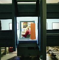 A set of photographs of a fluid dynamics experiment where a rudder / wing is placed into a wind tunnel.  Also shown are the unknown pieces of equipment involved. 6 images.