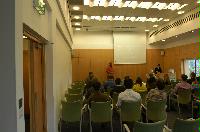 Photographs of a lecture on a planetary science entitled: 'Quaoar, crystalline water ice and all that...' by Helen Brand (UCL) and Helen Maynard (CSEC, UoE). Dr John Loveday is present as possibly the supervisor. The photographs were taken for a brochure in November 2005.