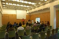 Photographs of a lecture on a planetary science entitled: 'Quaoar, crystalline water ice and all that...' by Helen Brand (UCL) and Helen Maynard (CSEC, UoE). Dr John Loveday is present as possibly the supervisor. The photographs were taken for a brochure in November 2005.