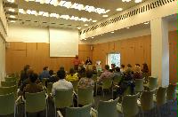 Photographs of a lecture on a planetary science entitled: 'Quaoar, crystalline water ice and all that...' by Helen Brand (UCL) and Helen Maynard (CSEC, UoE). Dr John Loveday is present as possibly the supervisor. The photographs were taken for a brochure in November 2005.