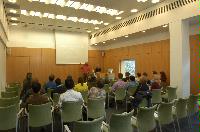 Photographs of a lecture on a planetary science entitled: 'Quaoar, crystalline water ice and all that...' by Helen Brand (UCL) and Helen Maynard (CSEC, UoE). Dr John Loveday is present as possibly the supervisor. The photographs were taken for a brochure in November 2005.