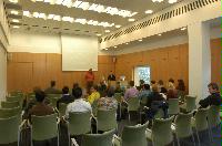 Photographs of a lecture on a planetary science entitled: 'Quaoar, crystalline water ice and all that...' by Helen Brand (UCL) and Helen Maynard (CSEC, UoE). Dr John Loveday is present as possibly the supervisor. The photographs were taken for a brochure in November 2005.