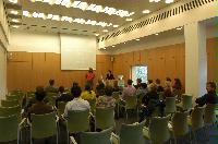 Photographs of a lecture on a planetary science entitled: 'Quaoar, crystalline water ice and all that...' by Helen Brand (UCL) and Helen Maynard (CSEC, UoE). Dr John Loveday is present as possibly the supervisor. The photographs were taken for a brochure in November 2005.