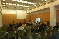 Photographs of a lecture on a planetary science entitled: 'Quaoar, crystalline water ice and all that...' by Helen Brand (UCL) and Helen Maynard (CSEC, UoE). Dr John Loveday is present as possibly the supervisor. The photographs were taken for a brochure in November 2005.
