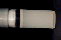 A sequence of photos showing the crystallization and then sedimentation of 2 substances.