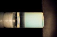 A sequence of photos showing the crystallization and then sedimentation of 2 substances.