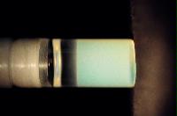 A sequence of photos showing the crystallization and then sedimentation of 2 substances.