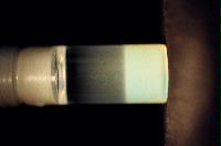 A sequence of photos showing the crystallization and then sedimentation of 2 substances.
