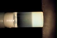 A sequence of photos showing the crystallization and then sedimentation of 2 substances.