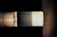 A sequence of photos showing the crystallization and then sedimentation of 2 substances.