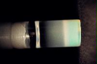 A sequence of photos showing the crystallization and then sedimentation of 2 substances.