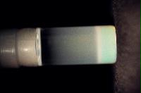 A sequence of photos showing the crystallization and then sedimentation of 2 substances.