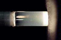 A sequence of photos showing the crystallization and then sedimentation of 2 substances.