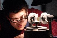 Photographs of Erik Brown performing a spectroscopy experiment, possibly to measure the spacing of the sodium doublet, during his 3rd Year Physics laboratories, January 2008.