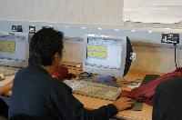 Photographs showing the class of the High Powered Computing MSc students 2005/2006, working in a computer lab suported by EPCC staff, including Dr Fiona J L Reid.