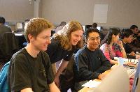 Photographs showing the class of the High Powered Computing MSc students 2005/2006, working in a computer lab suported by EPCC staff, including Dr Fiona J L Reid.