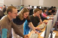 Photographs showing the class of the High Powered Computing MSc students 2005/2006, working in a computer lab suported by EPCC staff, including Dr Fiona J L Reid.
