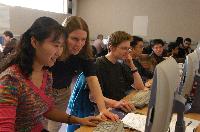 Photographs showing the class of the High Powered Computing MSc students 2005/2006, working in a computer lab suported by EPCC staff, including Dr Fiona J L Reid.